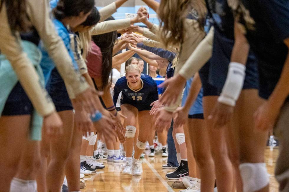 Foothill senior Madelyn Neibaur (13) runs through the team tunnel before the volleyball match a ...