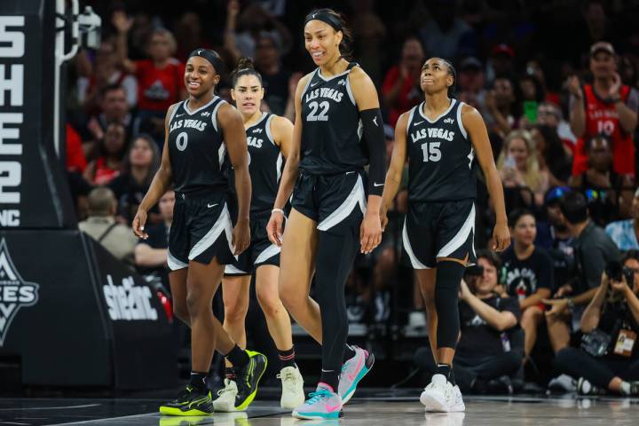 Aces teammates A'ja Wilson (22), Jackie Young (0), Kelsey Plum (10) and Tiffany Hayes (15) wal ...