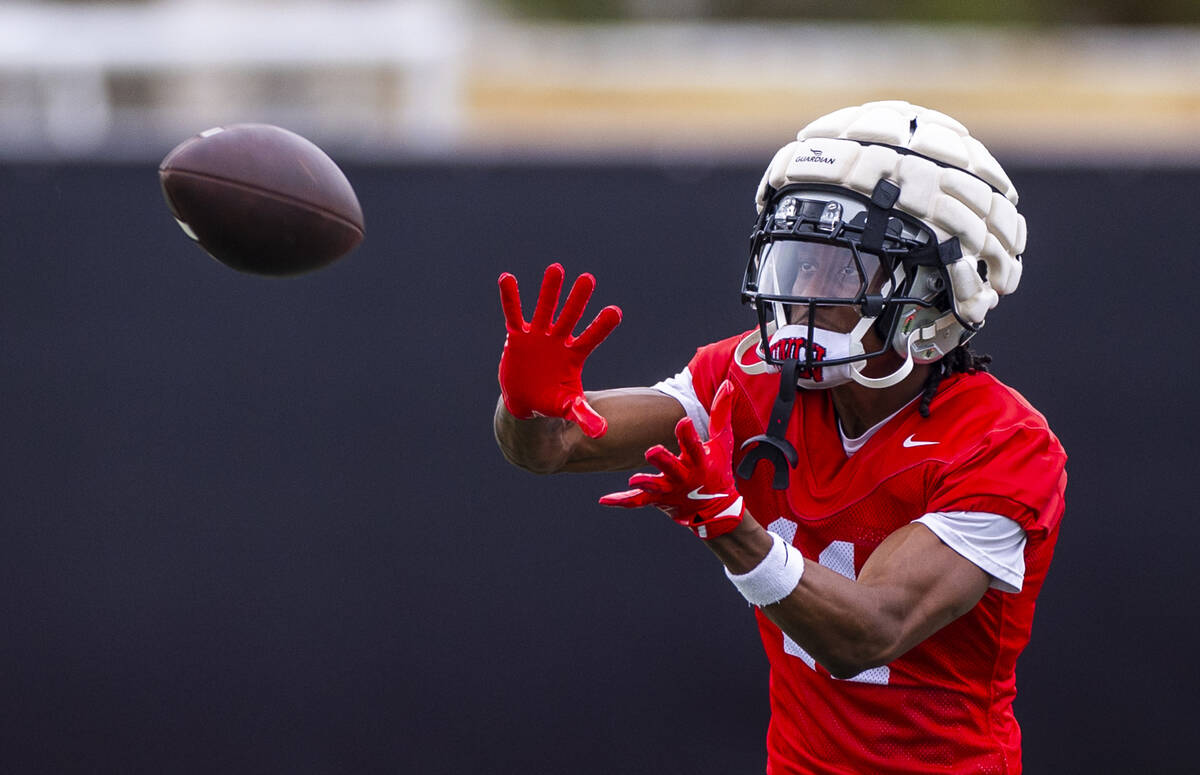 UNLV wide receiver Ricky White III (11) looks in a catch during the first day of football pract ...