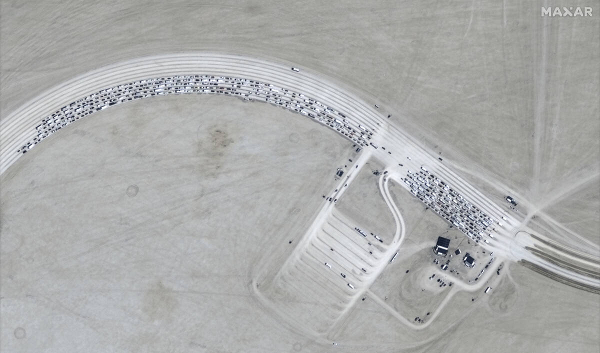 This image released by Maxar Technologies shows vehicles waiting to enter Burning Man 2024 fest ...