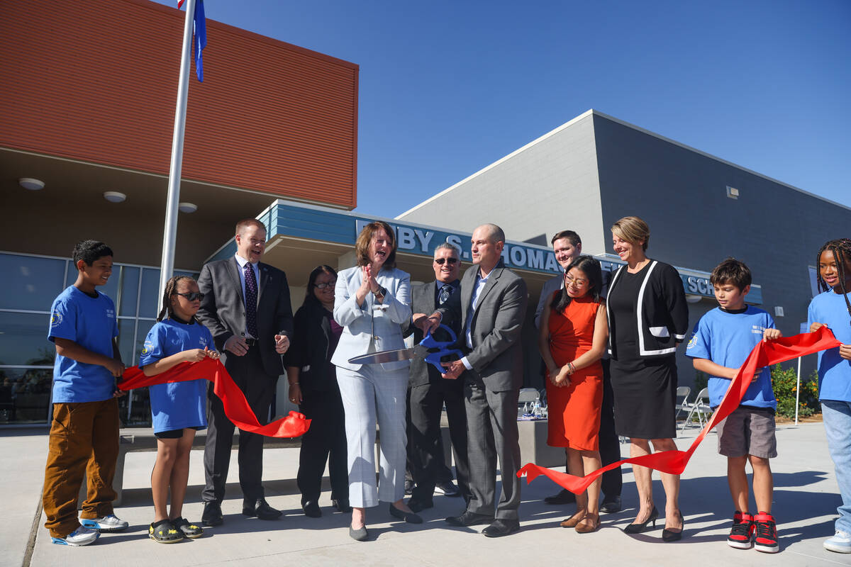 School officials including Principal Michael Stokes, center, and Clark County School District I ...