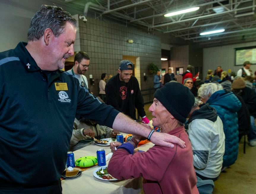 Deacon Tom Roberts, President and CEO of Catholic Charities of Southern Nevada, talks with dine ...