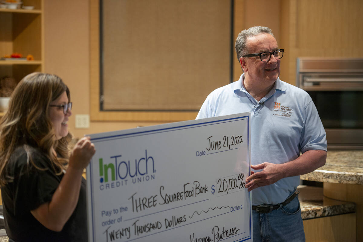 Karessa Pewtress of InTouch Credit Union, left, presents a check for $20,000 to Three Square Fo ...