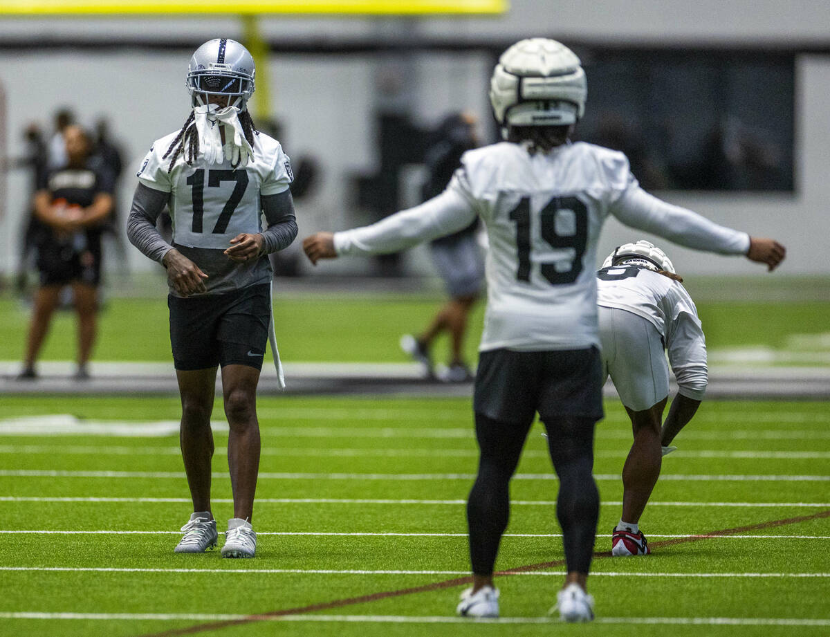 Raiders wide receiver Davante Adams (17) carries his gloves on his helmet during practice at th ...