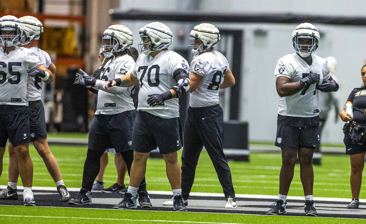 Raiders guard Jackson Powers-Johnson (70), center, and offensive tackle DJ Glaze (71), right, ...