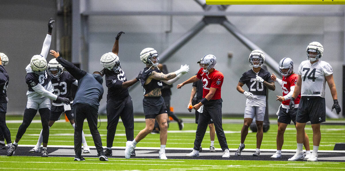 Raiders players warm up during practice at the Intermountain Health Performance Center on Tuesd ...