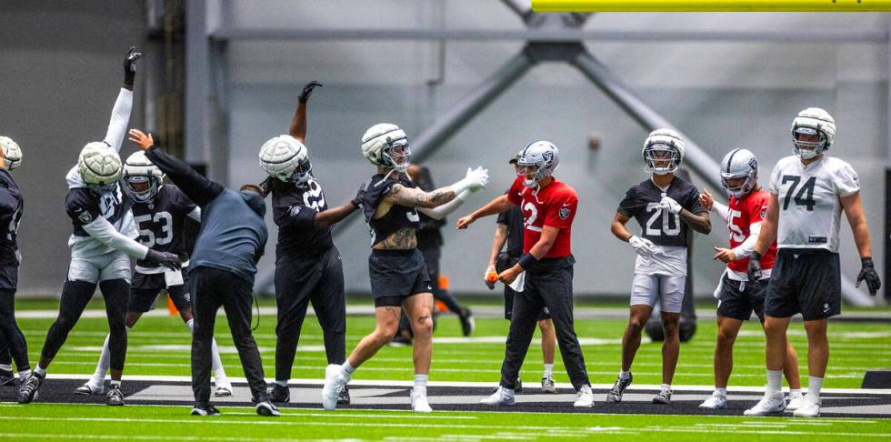 Raiders players warm up during practice at the Intermountain Health Performance Center on Tuesd ...