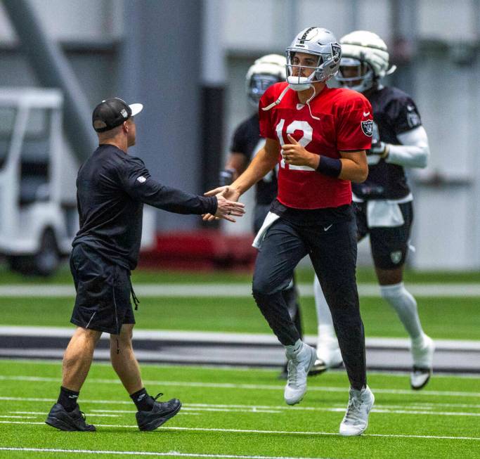 Raiders quarterback Aidan O'Connell (12) greets Assistant Strength and Conditioning Coach Deuce ...