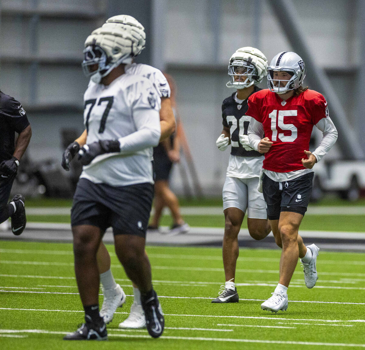 Raiders quarterback Gardner Minshew (15) runs sprints for warmups with teammates during practic ...