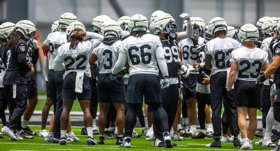 Raiders players gather on the field during practice at the Intermountain Health Performance Cen ...