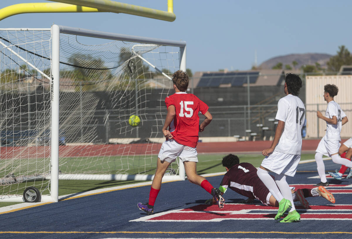 Coronado's Ben Aronow (15) kicks the ball past Cimarron-Memorial goalkeeper Dylan Crosby-Moghad ...