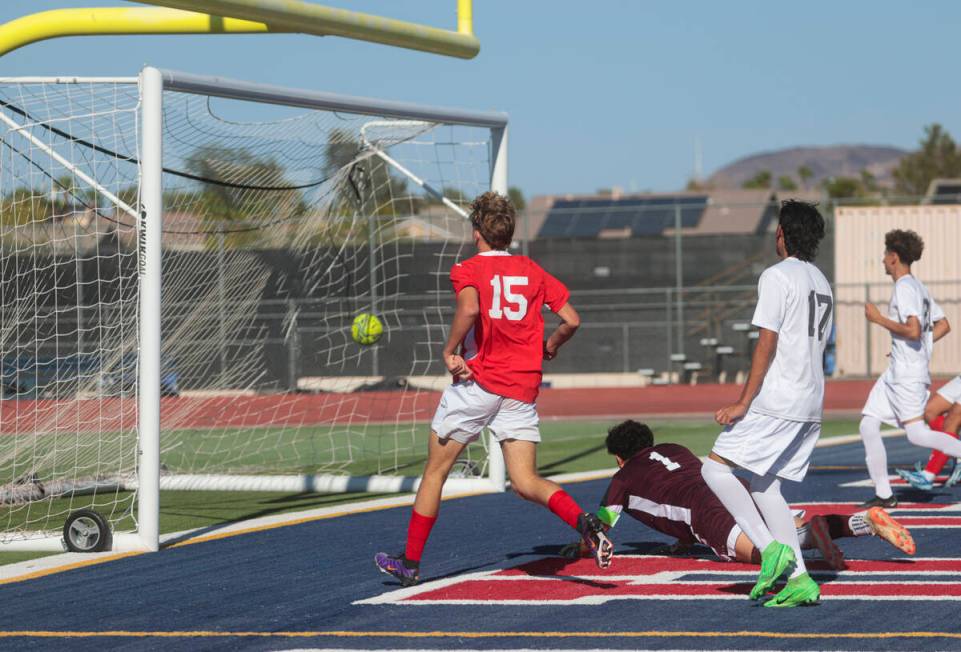 Coronado's Ben Aronow (15) kicks the ball past Cimarron-Memorial goalkeeper Dylan Crosby-Moghad ...