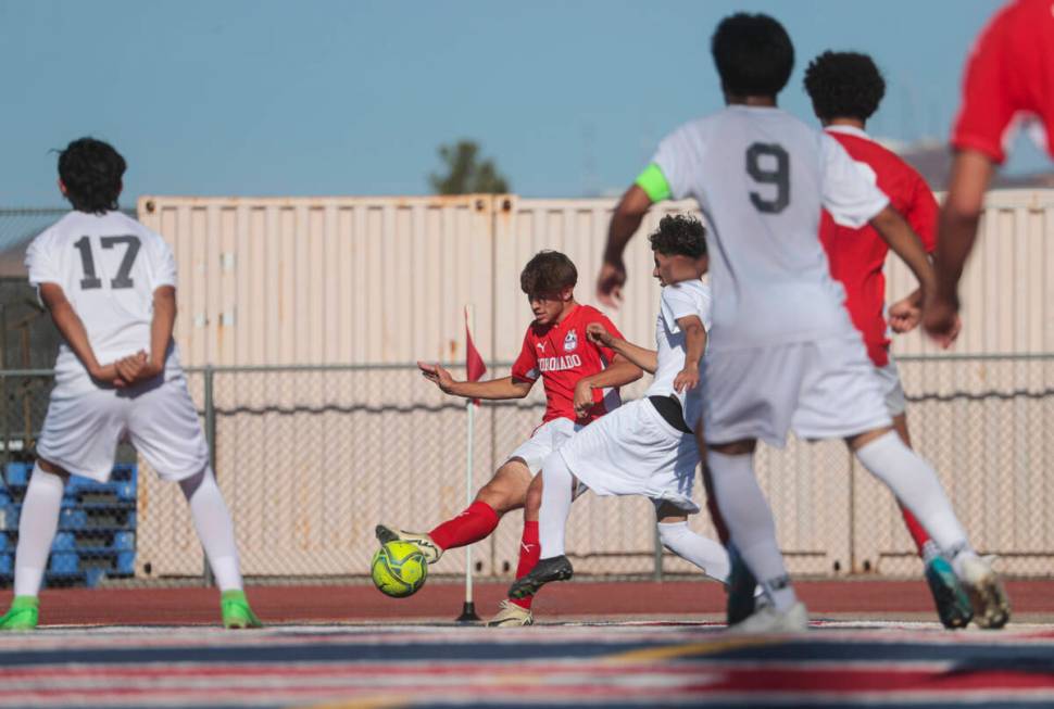 Coronado's Gavin Flickinger (11) kicks the ball past Cimarron-Memorial's Said Lopez, right, to ...