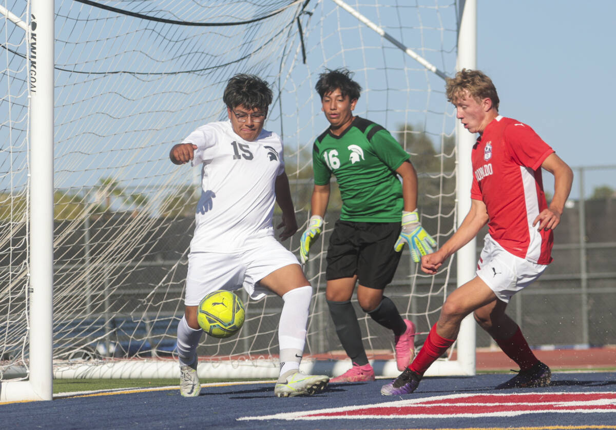 Cimarron-Memorial's defender Alan Soriano (15) kicks the ball away from Coronado's Ben Aronow, ...