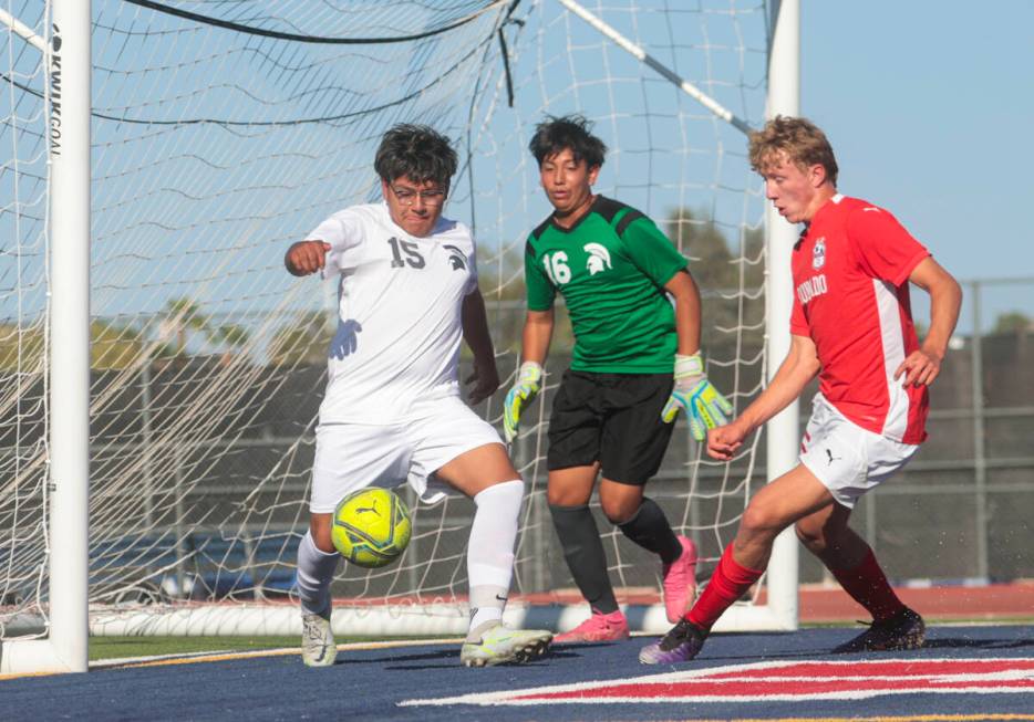 Cimarron-Memorial's defender Alan Soriano (15) kicks the ball away from Coronado's Ben Aronow, ...