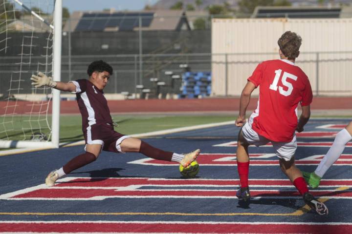 Coronado's defender Ben Aronow (15) kicks the ball past Cimarron-Memorial goalkeeper Dylan Cros ...