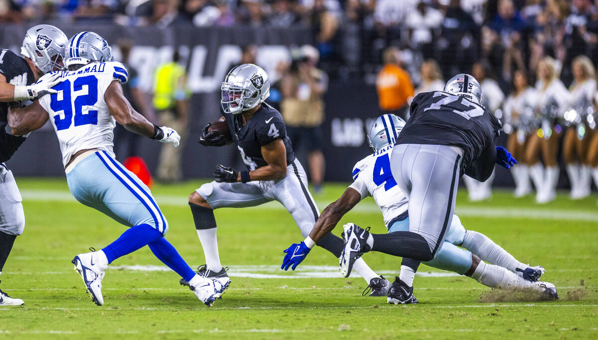 Raiders wide receiver Jalen Guyton (4) avoids a tackle against the Dallas Cowboys during the se ...