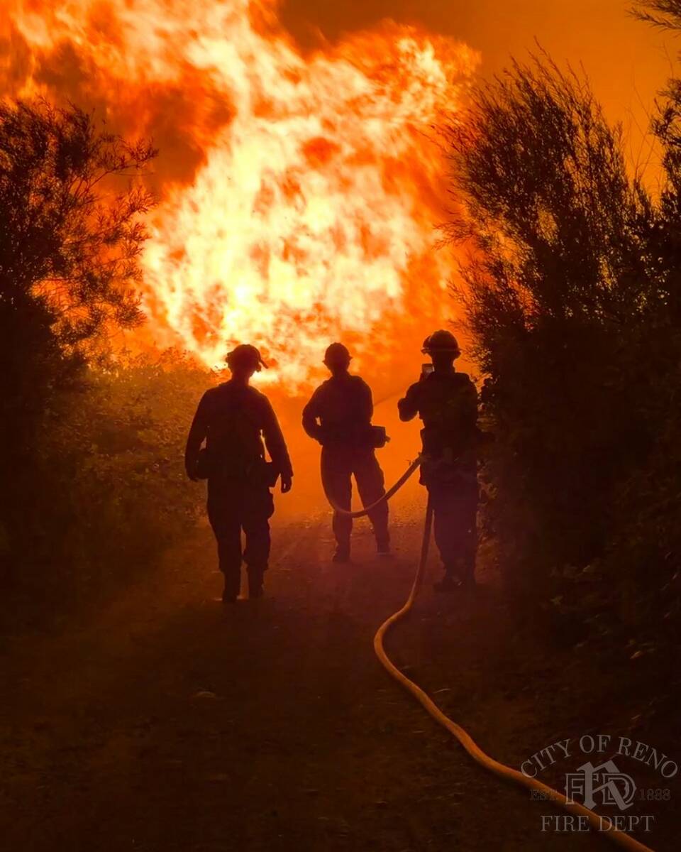 Firefighters work to contain the Gold Ranch Fire, which burned near the town of Verdi in Washoe ...