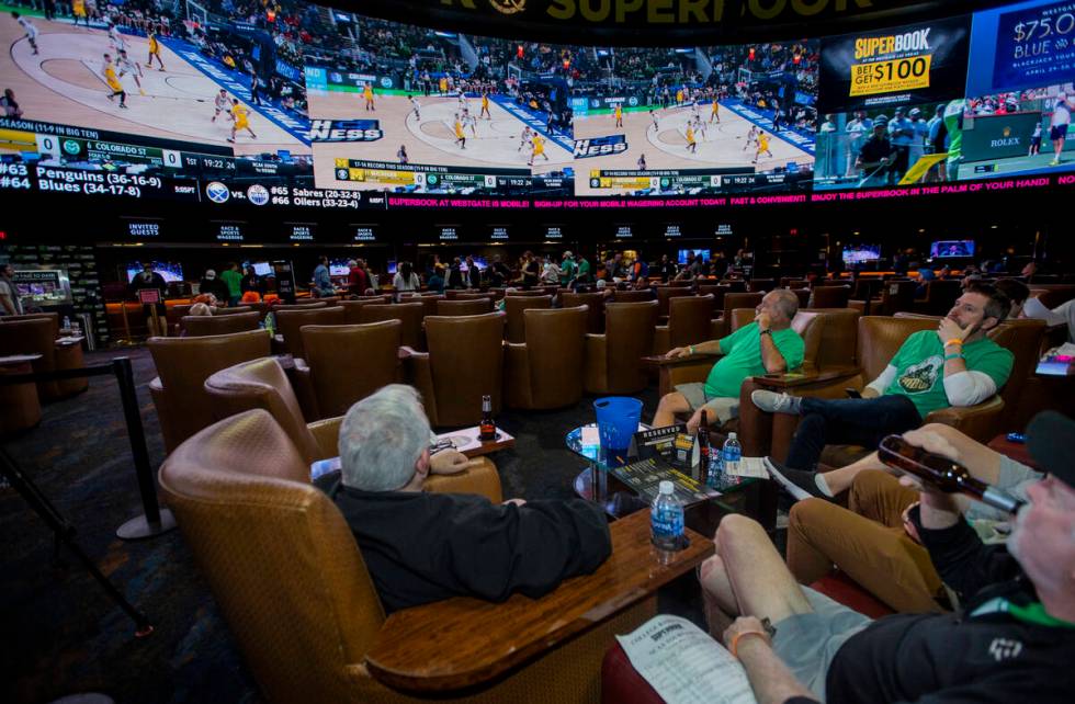 Fans look to the big screens as March Madness begins in the Superbook at Westgate on Thursday, ...