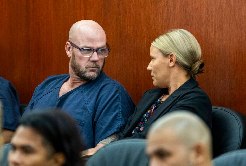 Defendant Ricky Lee Trader speaks with attorney Anna Clark as they prepare for a hearing on an ...