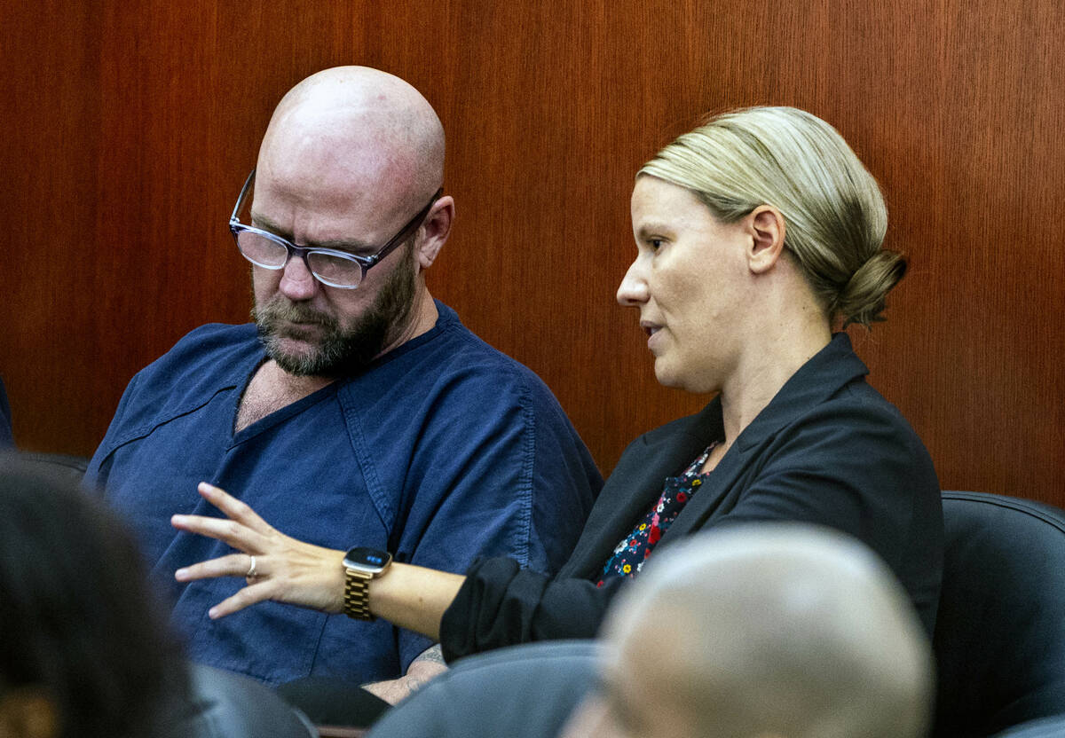 Defendant Ricky Lee Trader speaks with attorney Anna Clark as they prepare for a hearing on an ...