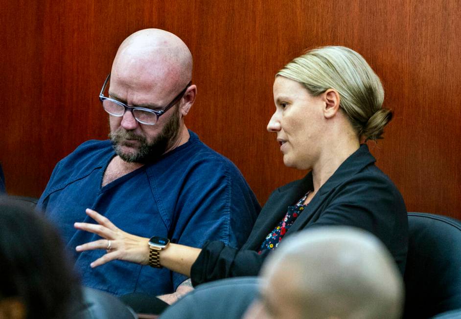 Defendant Ricky Lee Trader speaks with attorney Anna Clark as they prepare for a hearing on an ...