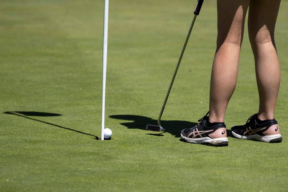 Clark’s Audrey Lac putts her ball into the hole during the Class 5A Mountain League girl ...