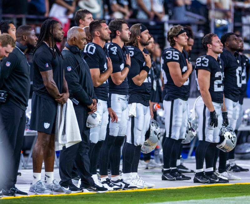 Raiders wide receiver Davante Adams (17) and teammates stand for the National Anthem as they fa ...