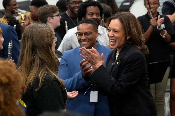 Democratic presidential nominee Vice President Kamala Harris speaks to marching band members at ...