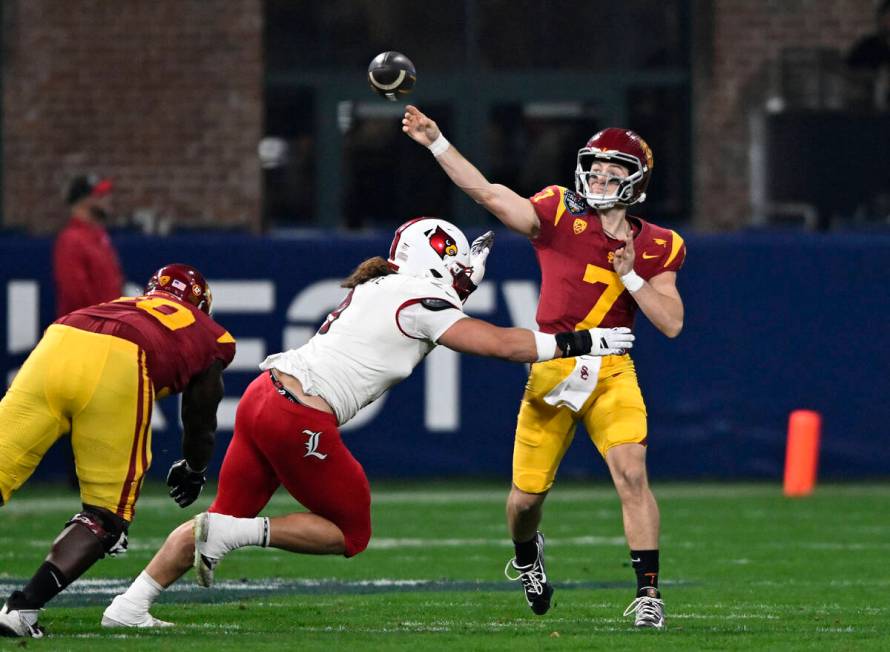 FILE - Southern California quarterback Miller Moss (7) throws a pass under pressure from Louisv ...