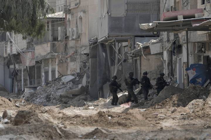 Members of Israeli forces patrol a street during a military operation in the West Bank refugee ...