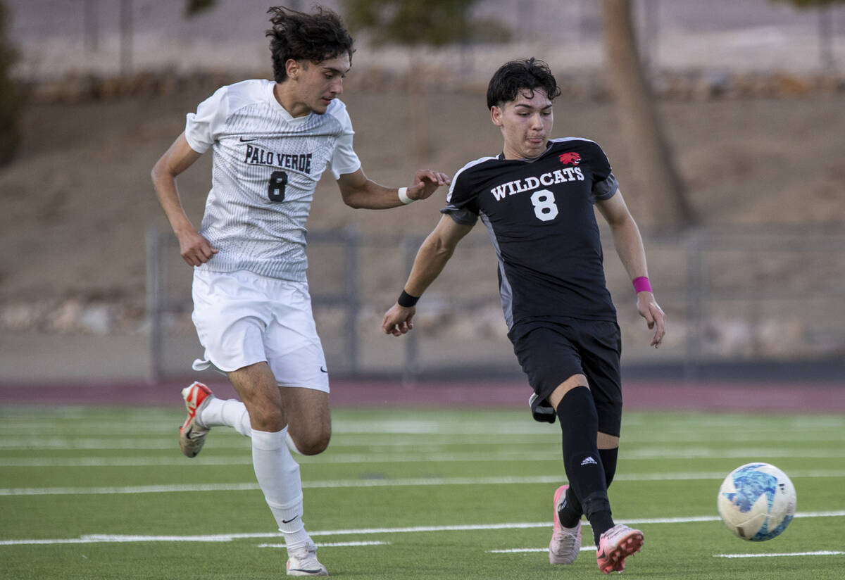 Las Vegas High senior Oscar Sandoval (8) kicks the ball away from Palo Verde junior Josemartin ...