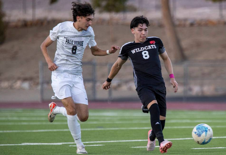 Las Vegas High senior Oscar Sandoval (8) kicks the ball away from Palo Verde junior Josemartin ...