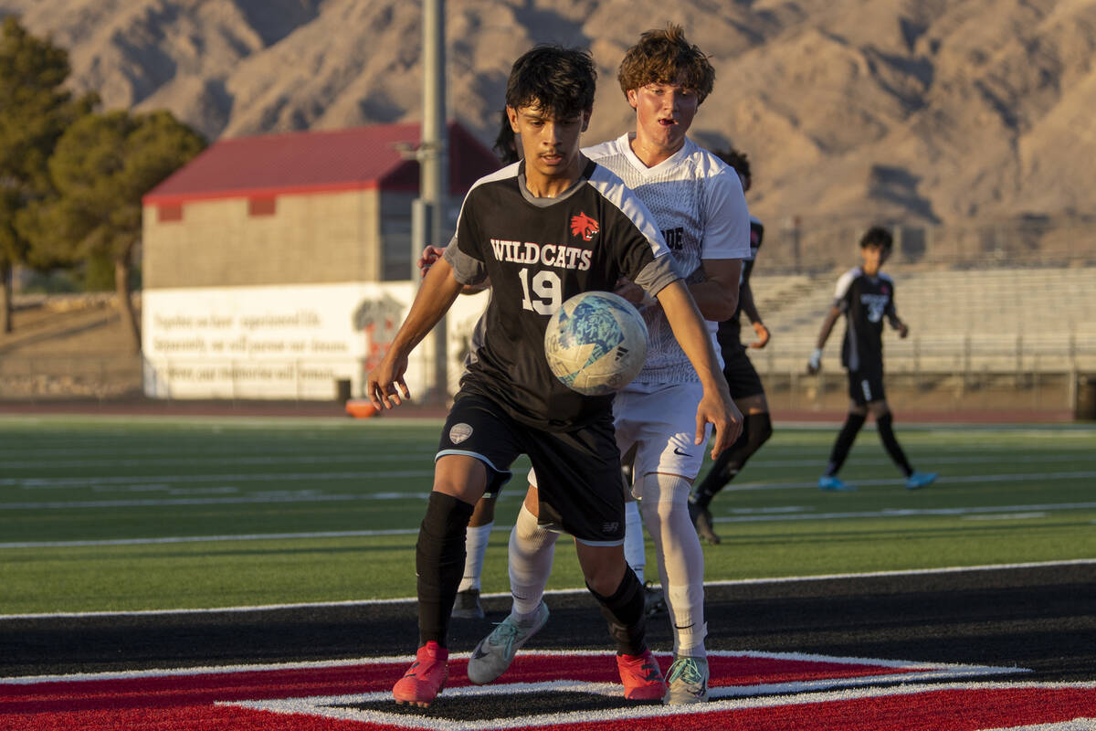 Las Vegas High junior Lex Madrigal (19) and Palo Verde senior Jaxon Law (2) compete for the bal ...