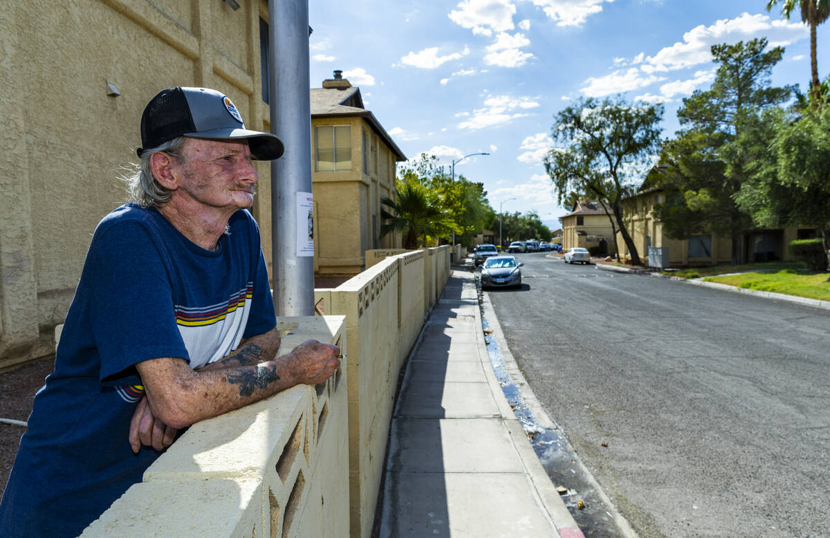 Resident Winfred Cooch enjoys a smoke along Natalee Drive in the Somerset Park community where ...