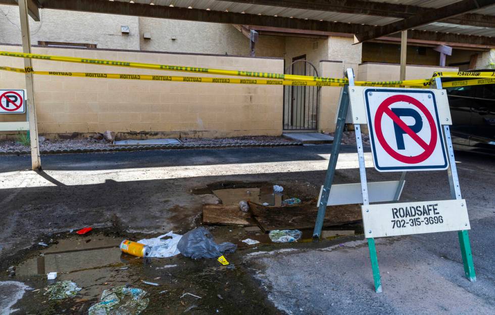 Caution tape is wrapped about a carport area as water continues to pool along Natalee Drive whe ...