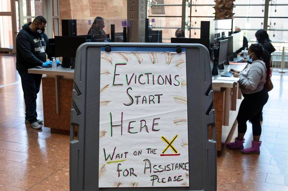 Tenants, who received an eviction notice from their landlord, fill out forms at the Civil Law S ...