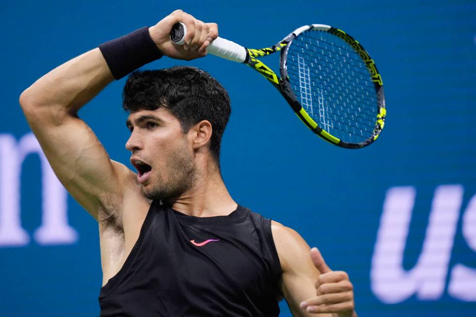 Carlos Alcaraz, of Spain returns a shot to Botic van de Zandschulp, of the Netherlands, during ...