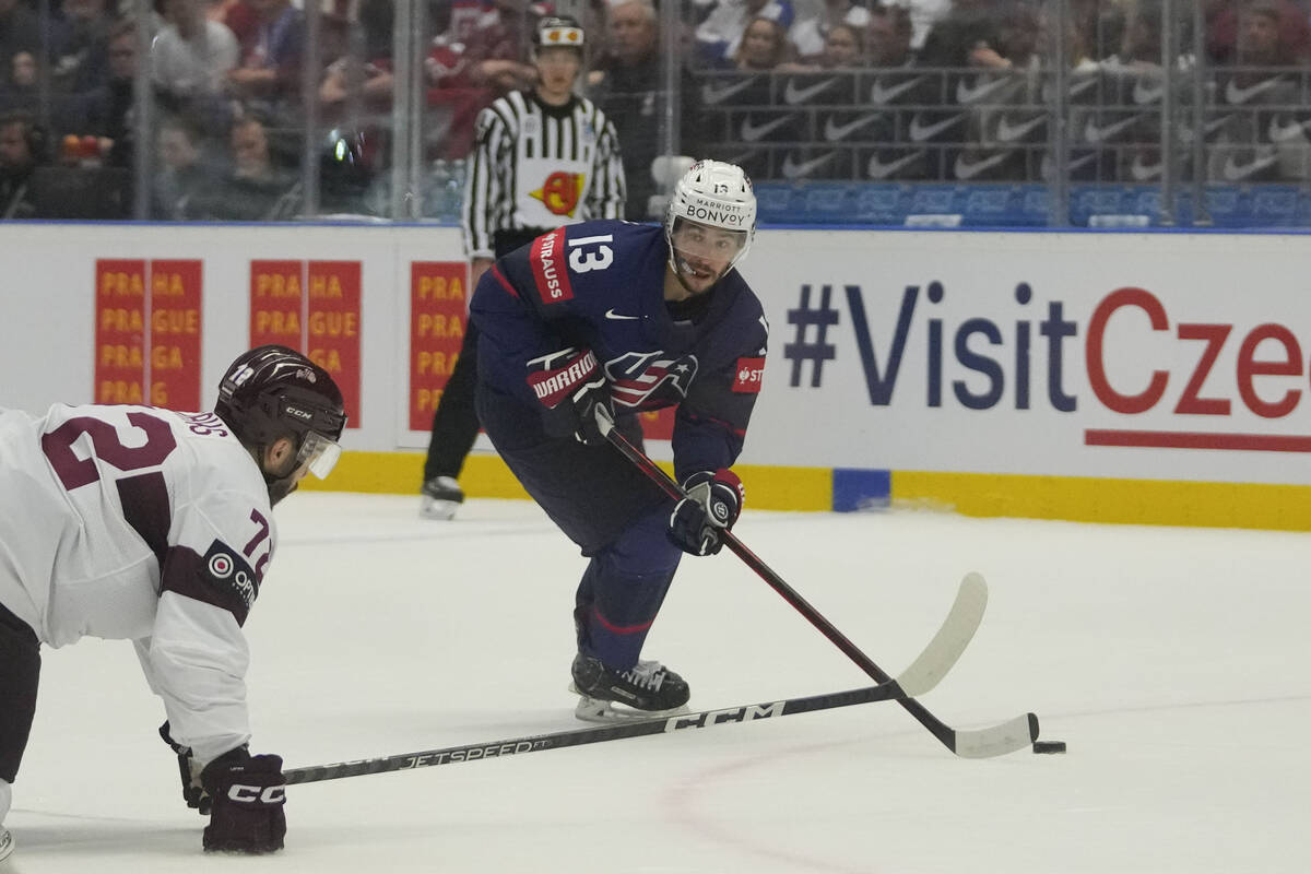 Unted States' Johnny Gaudreau, right, challenges for a puck with Latvia's Janis Jaks during the ...