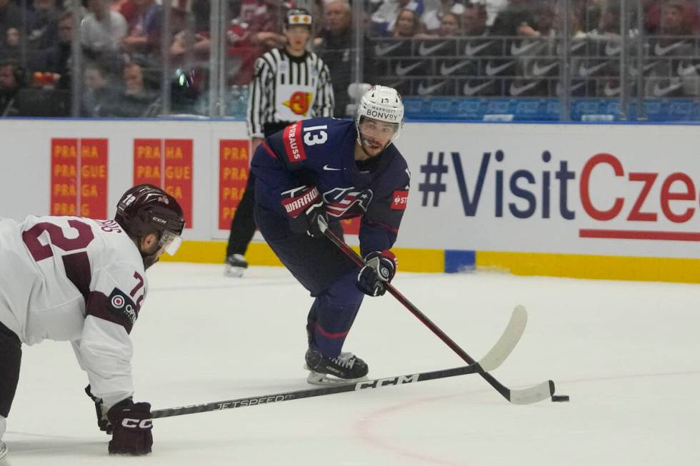 Unted States' Johnny Gaudreau, right, challenges for a puck with Latvia's Janis Jaks during the ...