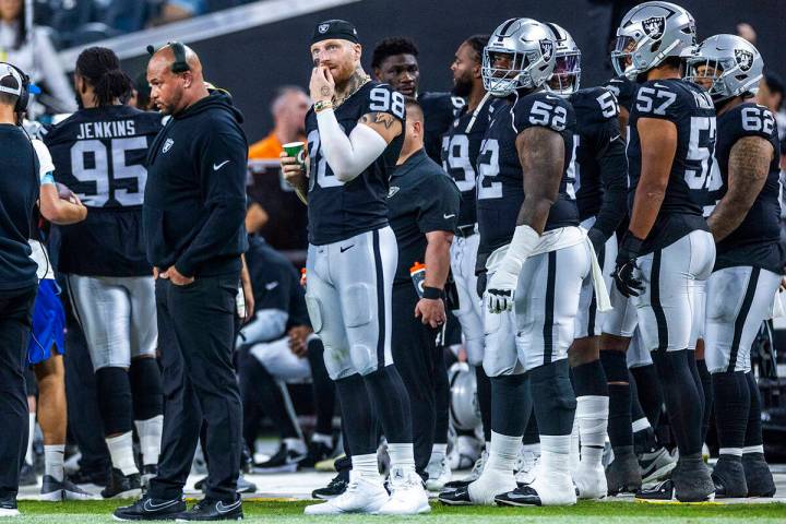 Raiders head coach Antonio Pierce appears dismayed as defensive end Maxx Crosby (98) chews his ...