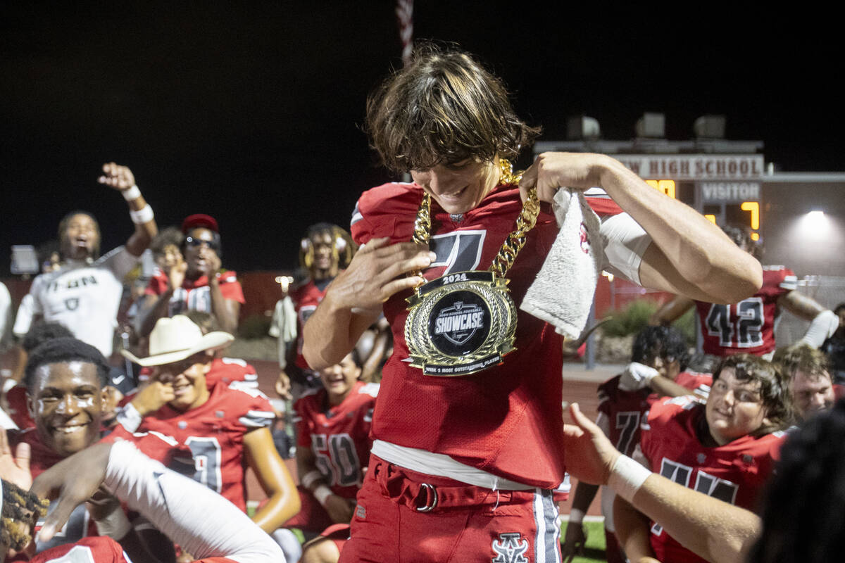 Arbor View quarterback Thaddeus Thatcher (7) is awarded the Raiders High School Showcase Most O ...