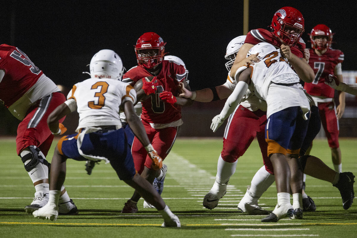 Arbor View running back Kamareion Bell (0) attempts to run up the middle during the Class 5A hi ...