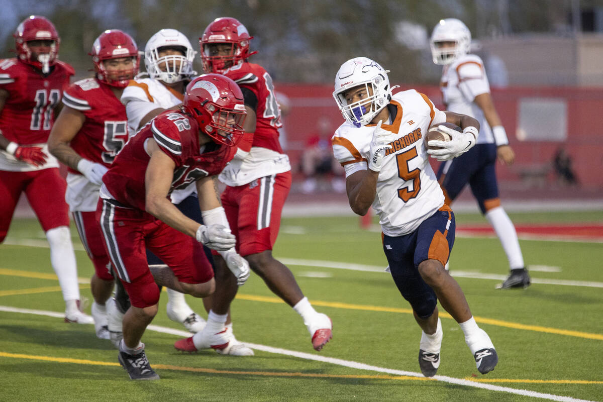 Legacy halfback Zaione Henderson (5) runs past the Arbor View defense during the Class 5A high ...