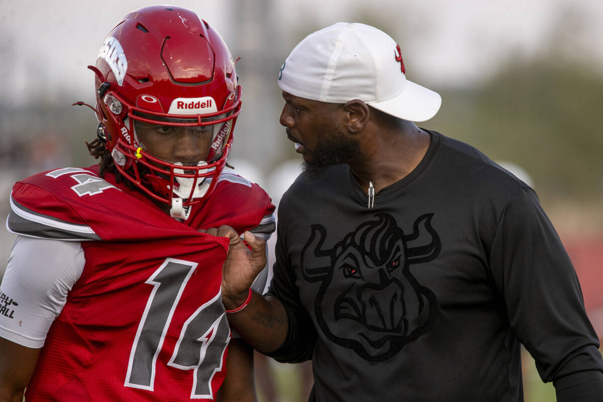 Arbor View Head Coach Marlon Barnett talks to cornerback JT Cole (14) after receiving a penalty ...