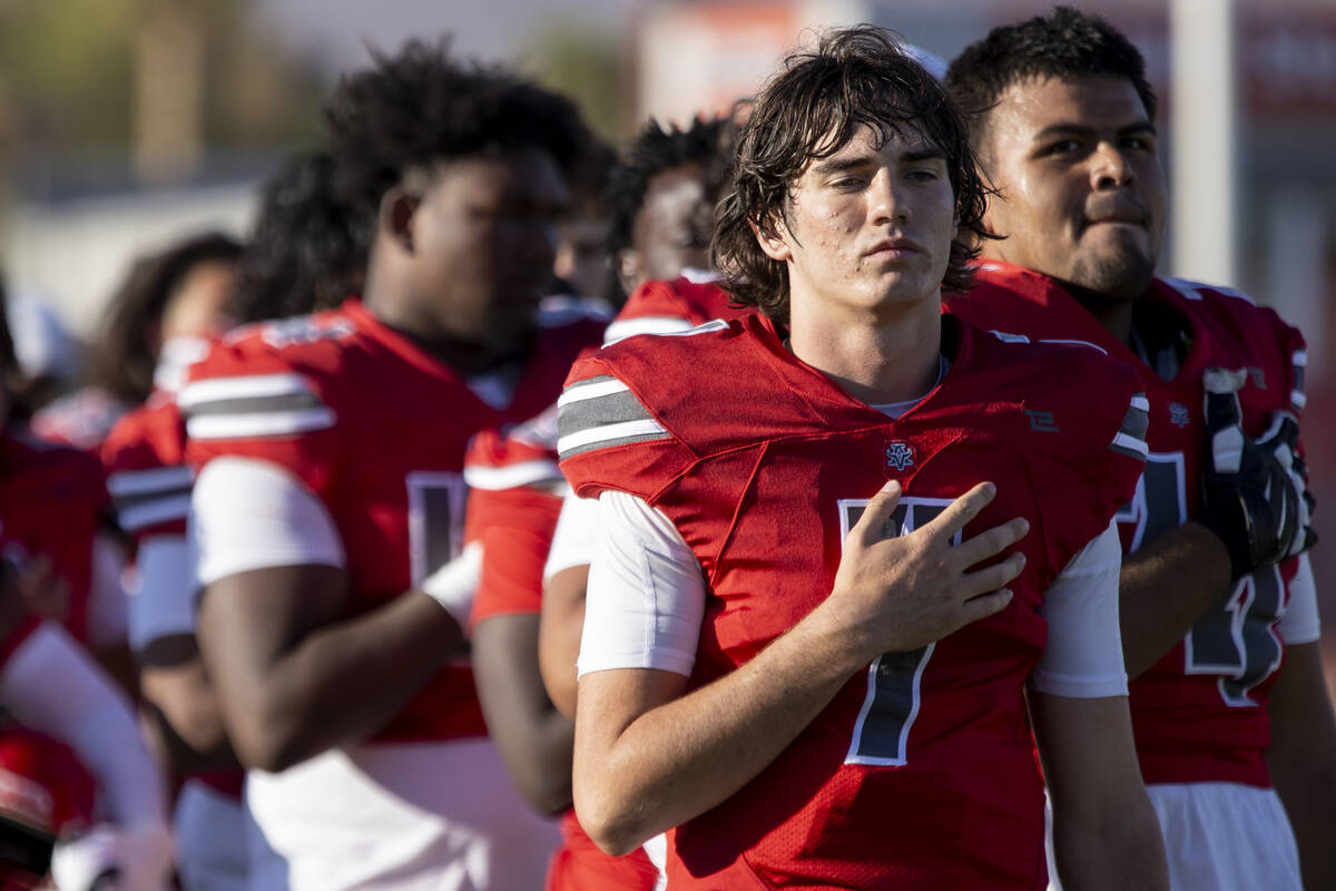 Arbor View quarterback Thaddeus Thatcher (7) places his hand on his chest as the national anthe ...