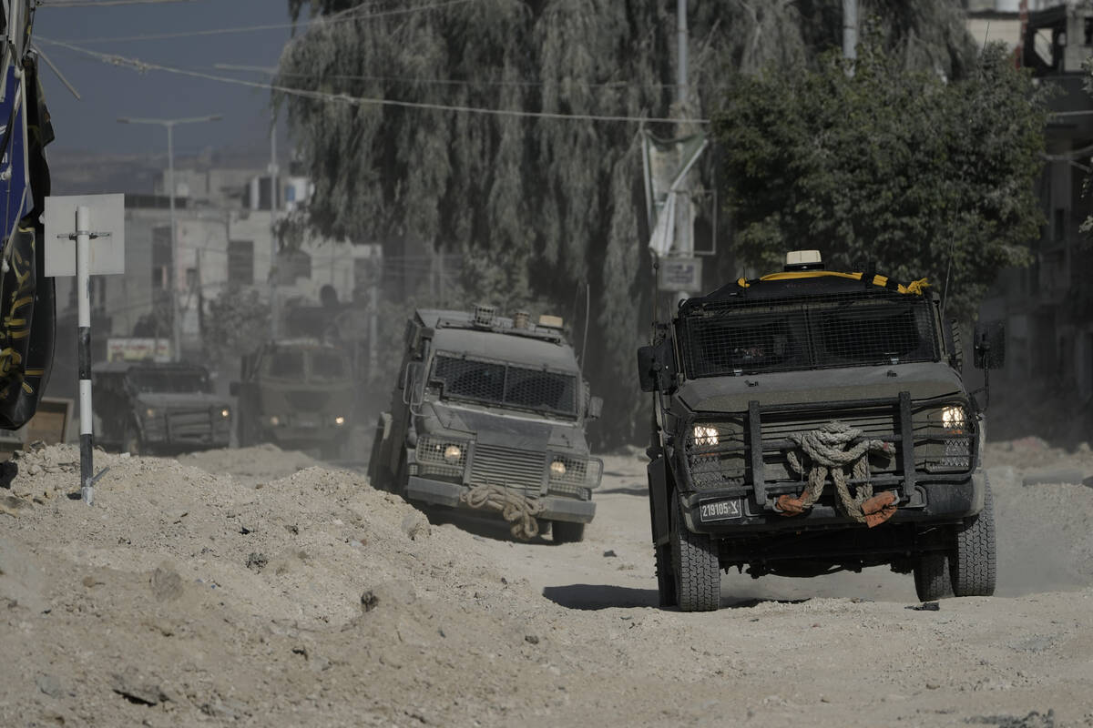 Israeli armoured vehicles move on a street during a military operation in the West Bank refugee ...