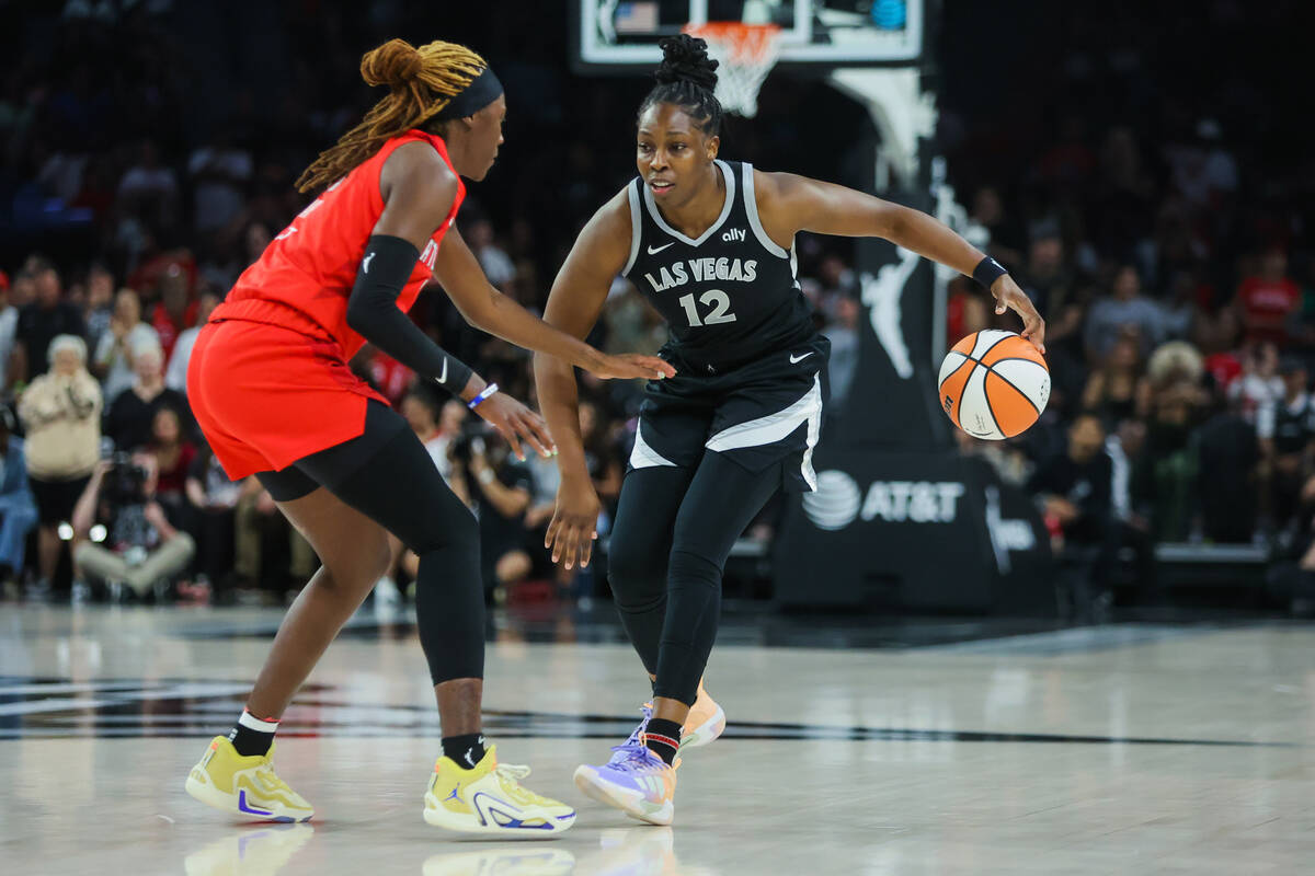 Aces guard Chelsea Gray (12) dribbles the ball as Atlanta Dream guard Rhyne Howard (10) guards ...