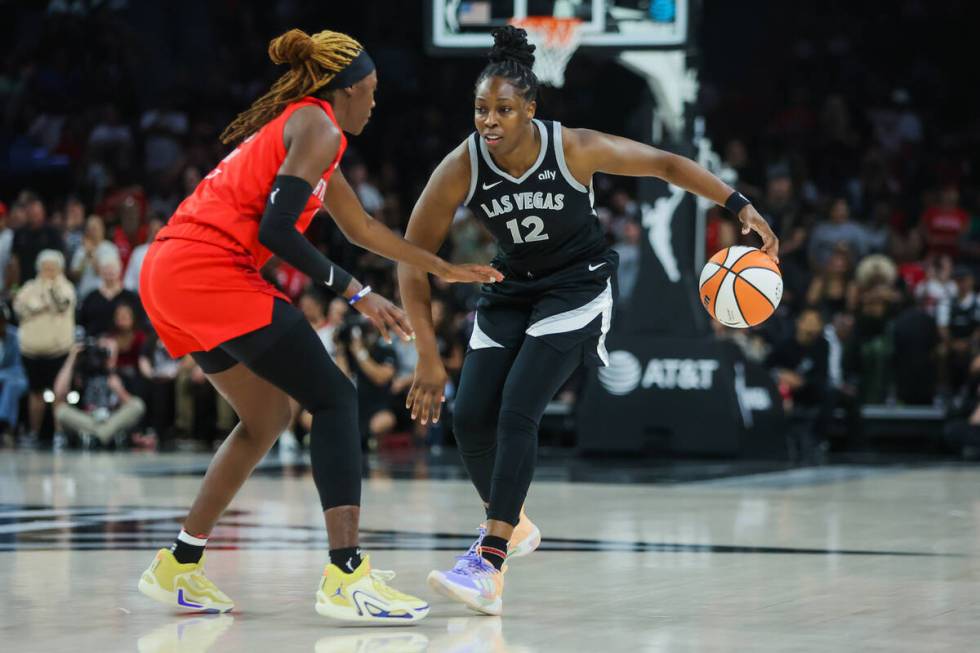 Aces guard Chelsea Gray (12) dribbles the ball as Atlanta Dream guard Rhyne Howard (10) guards ...