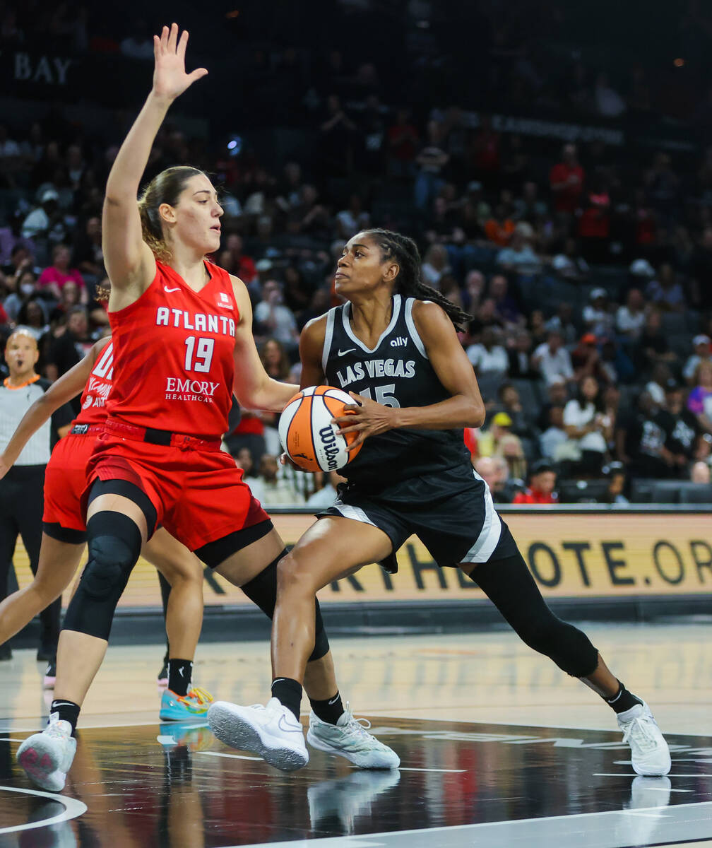 Aces guard Tiffany Hayes (15) drives the ball to the net as Atlanta Dream forward Lorela Cubaj ...